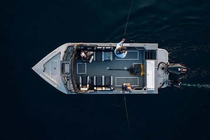 Slide: The Image of Manufacturer Provided Image: 2025 Lund 200 Heavy Gauge boat on calm water, surrounded by lush greenery. - 21