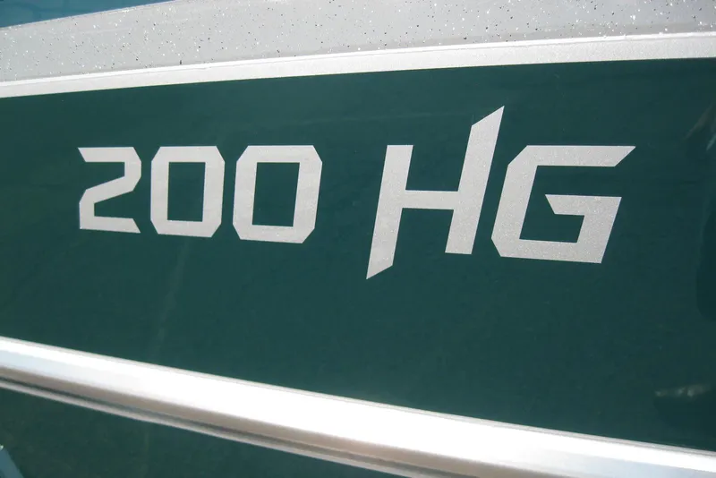 Slide: The Image of 2026 Lund 200 Heavy Gauge boat on trailer outside a marine dealership. - 3