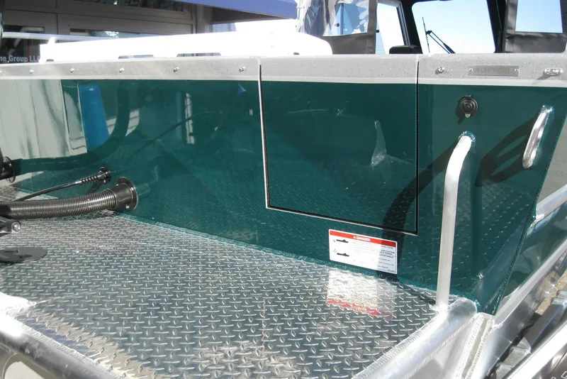 Slide: The Image of 2026 Lund 200 Heavy Gauge boat with Mercury Pro XS outboard motor, docked outdoors. - 8