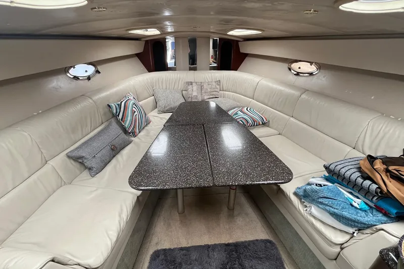 Slide: The Image of Luxurious interior of 2004 Formula 400 Super Sport Crossover with plush seating and elegant table. - 13