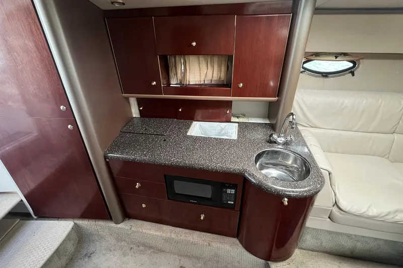 Slide: The Image of Luxurious 2004 Formula 400 Super Sport Crossover yacht interior with kitchenette and seating area. - 14