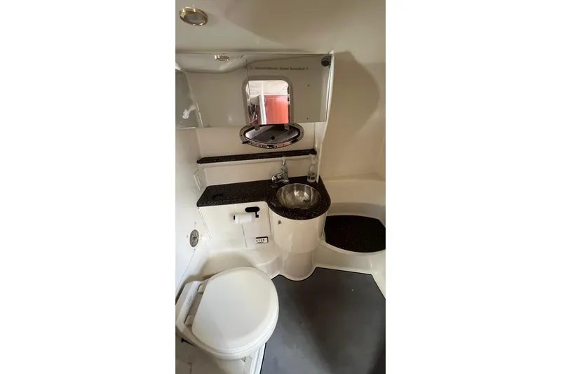 Slide: The Image of 2004 Formula 400 Super Sport Crossover boat bathroom with sink and toilet. - 15