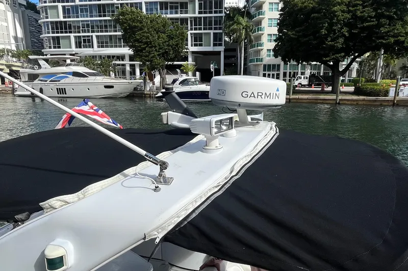 Slide: The Image of 2004 Formula 400 Super Sport Crossover with Garmin radar, docked near modern buildings. - 19