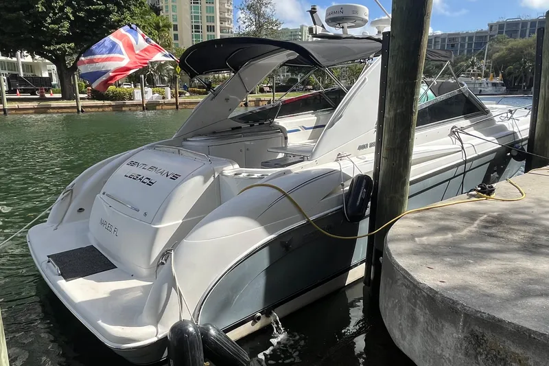 Slide: The Image of 2004 Formula 400 Super Sport Crossover yacht docked, featuring sleek design and British flag. - 20