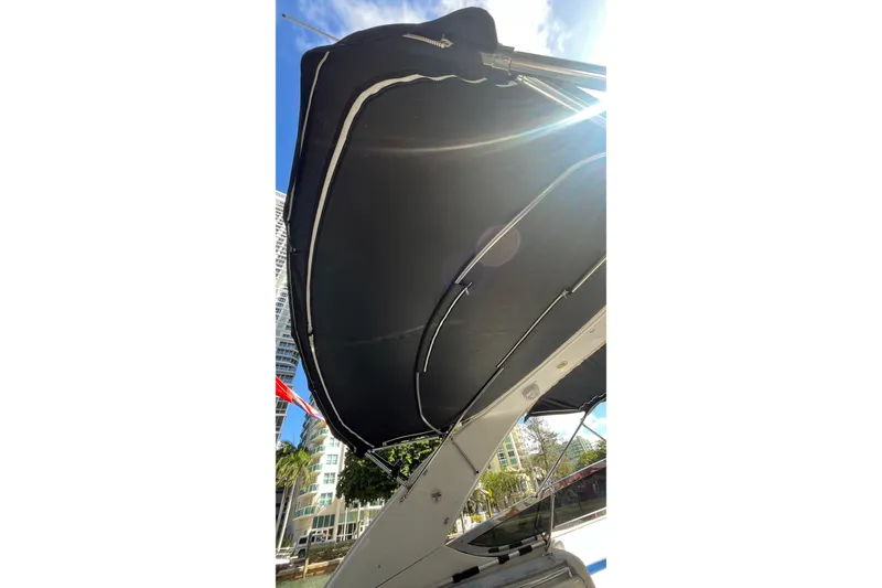 Slide: The Image of 2004 Formula 400 Super Sport Crossover boat canopy under sunny sky. - 23