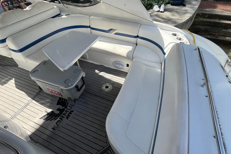 Slide: The Image of 2004 Formula 400 Super Sport Crossover boat interior with seating and table. - 25