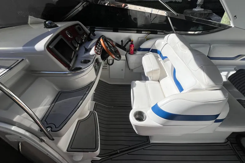 Slide: The Image of Interior of a 2004 Formula 400 Super Sport Crossover boat with white and blue seating. - 30