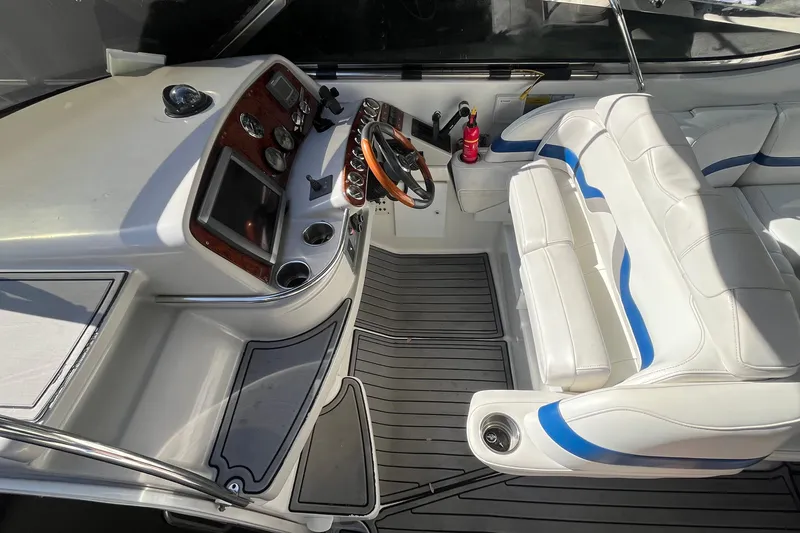 Slide: The Image of Cockpit of 2004 Formula 400 Super Sport Crossover with white seating and modern controls. - 32