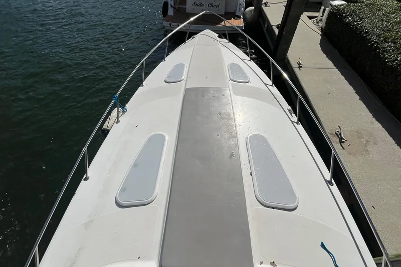Slide: The Image of 2004 Formula 400 Super Sport Crossover boat docked, top view of deck and railing. - 34