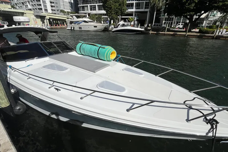Slide: The Image of 2004 Formula 400 Super Sport Crossover boat docked in a marina with urban backdrop. - 35