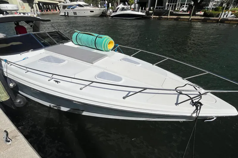 Slide: The Image of 2004 Formula 400 Super Sport Crossover docked, featuring sleek design and spacious deck. - 36