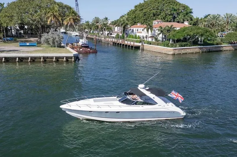 Slide: The Image of 2004 Formula 400 Super Sport Crossover yacht cruising in a scenic waterway. - 4