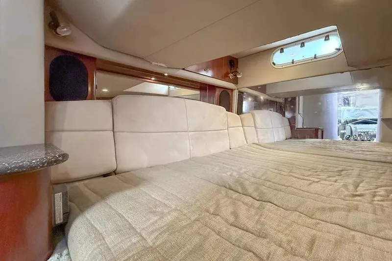 Slide: The Image of Interior cabin of 2004 Formula 400 Super Sport Crossover with plush bedding and porthole window. - 8