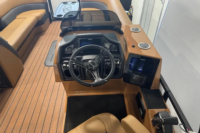 Slide: The Image of 2026 Bentley Pontoons Elite 253 Swingback dashboard with modern controls and luxurious seating. - 21