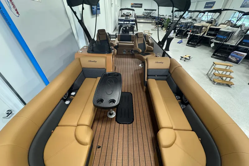 Slide: The Image of 2026 Bentley Pontoons Elite 253 Swingback with luxurious seating and sleek design in showroom. - 22
