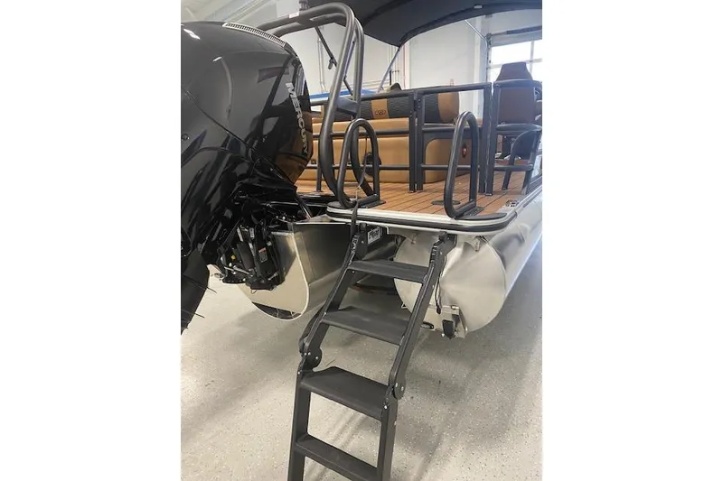 Slide: The Image of 2026 Bentley Pontoons Elite 253 Swingback with ladder and outboard motor in showroom. - 23