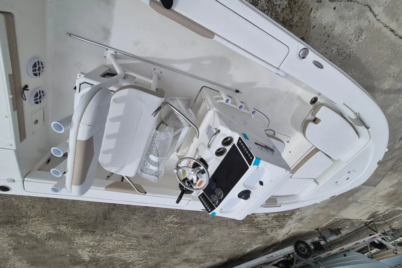 Slide: The Image of 2026 Robalo 226 Cayman boat interior with steering console and seating. - 4