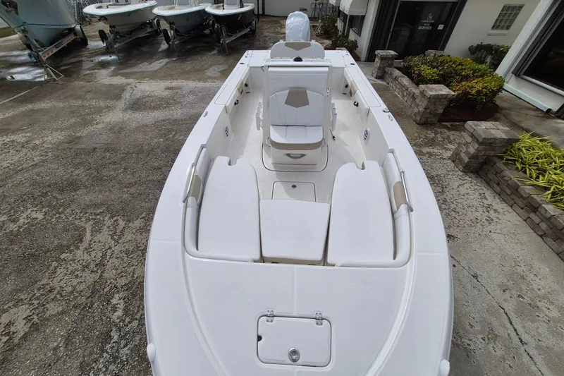 Slide: The Image of 2026 Robalo 226 Cayman boat, white interior, docked at marina. - 5