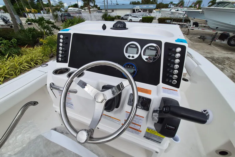 Slide: The Image of 2026 Robalo 226 Cayman boat dashboard with steering wheel and control panel. - 8