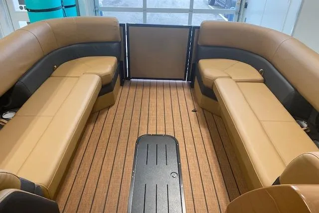 Slide: The Image of Interior of 2026 Bentley Pontoons Elite 253 Swingback with tan seating and wood flooring. - 11