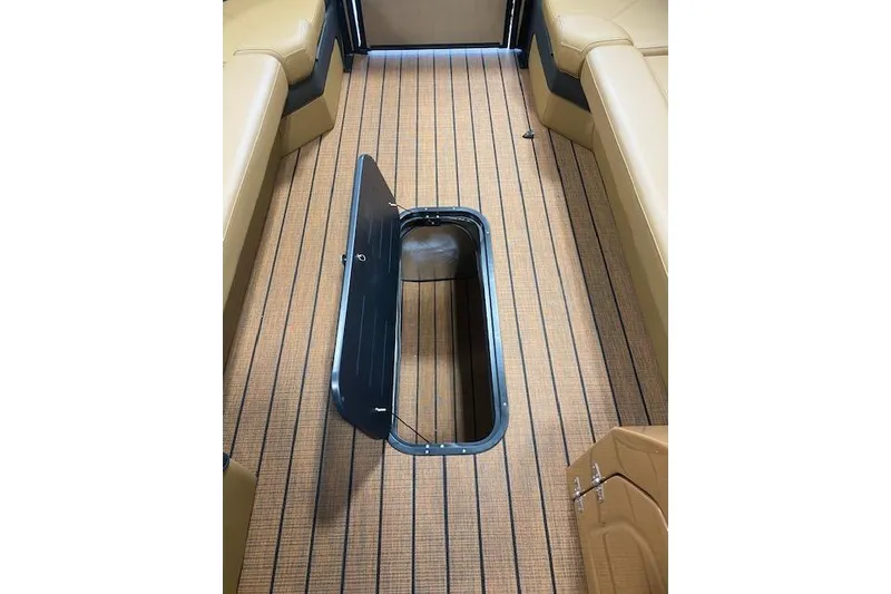 Slide: The Image of 2026 Bentley Pontoons Elite 253 Swingback interior with open floor storage compartment. - 13