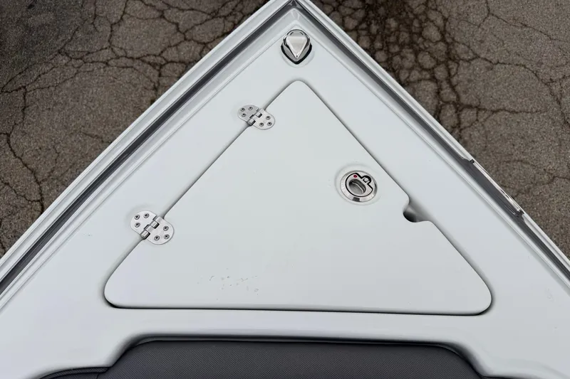 Slide: The Image of 2023 Crownline 280 SS boat bow storage compartment with hinges and latch. - 2