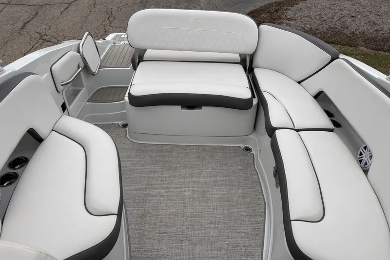 Slide: The Image of 2023 Crownline 280 SS boat interior with white cushioned seating and gray flooring. - 5