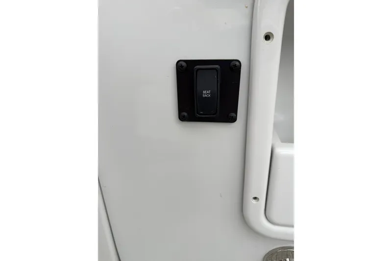 Slide: The Image of 2023 Crownline 280 SS boat seat back switch on white panel. - 6