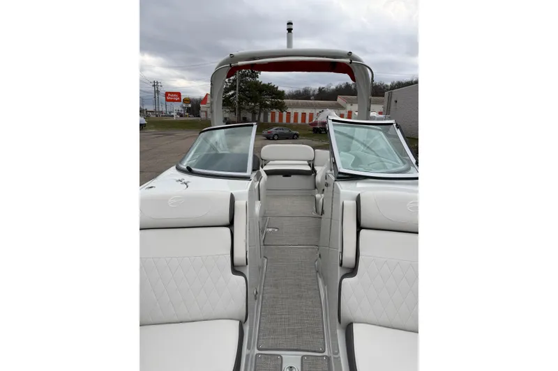 Slide: The Image of 2023 Crownline 280 SS boat interior with white seating and open windshield. - 8