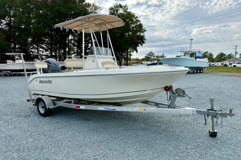 The Image of 2016 Release 180 CC boat on trailer, parked outdoors under cloudy sky. - 0