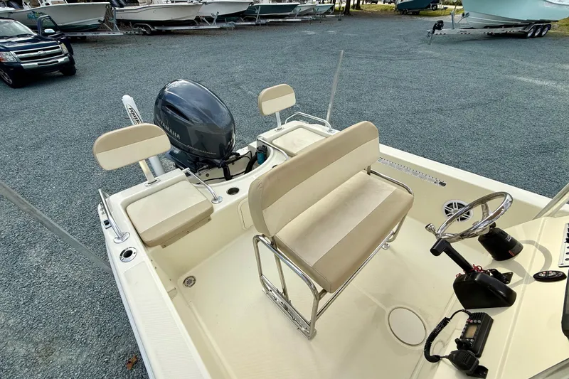 Slide: The Image of 2016 Release 180 CC boat with Yamaha outboard motor, beige seating, and steering console. - 15