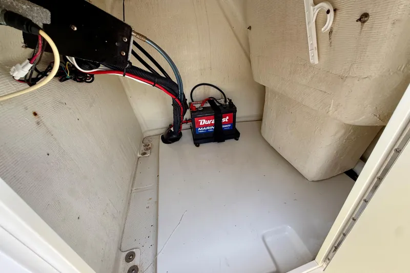 Slide: The Image of 2016 Release 180 CC boat interior with marine battery and wiring. - 21