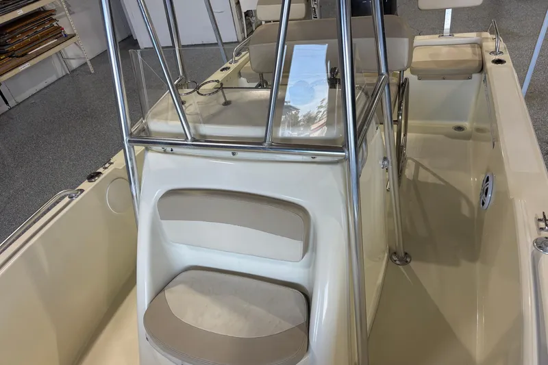 Slide: The Image of Interior view of a 2016 Release 180 CC boat, featuring seating and console. - 22
