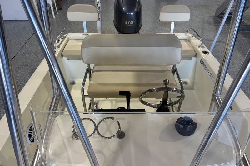 Slide: The Image of Interior view of a 2016 Release 180 CC boat with steering wheel and seating. - 24