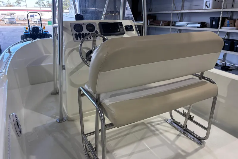 Slide: The Image of Interior of a 2016 Release 180 CC boat with steering console and seating. - 27