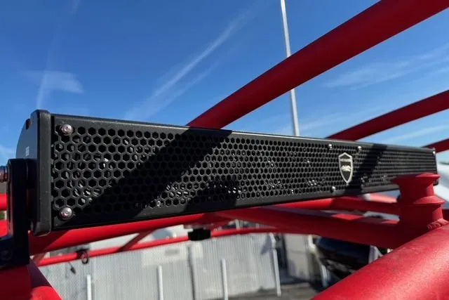 Slide: The Image of 2020 Yamaha Boats 242X E-Series soundbar on red frame, under clear blue sky. - 13