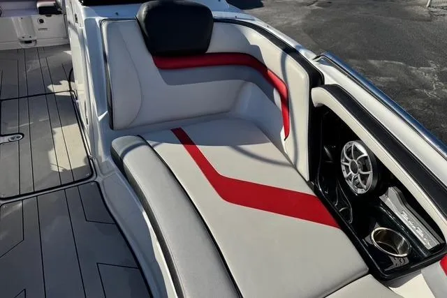 Slide: The Image of 2020 Yamaha Boats 242X E-Series interior with red and gray seating and speaker system. - 15