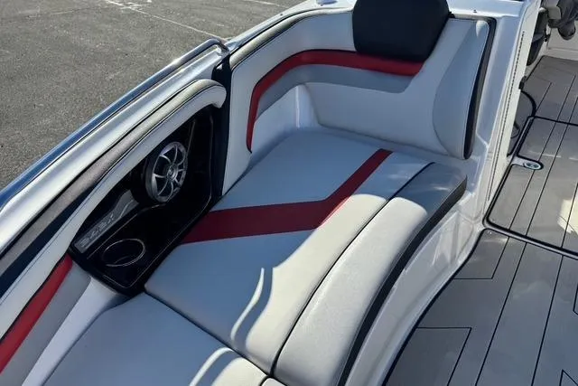 Slide: The Image of 2020 Yamaha Boats 242X E-Series interior seating with red accents and speaker system. - 16