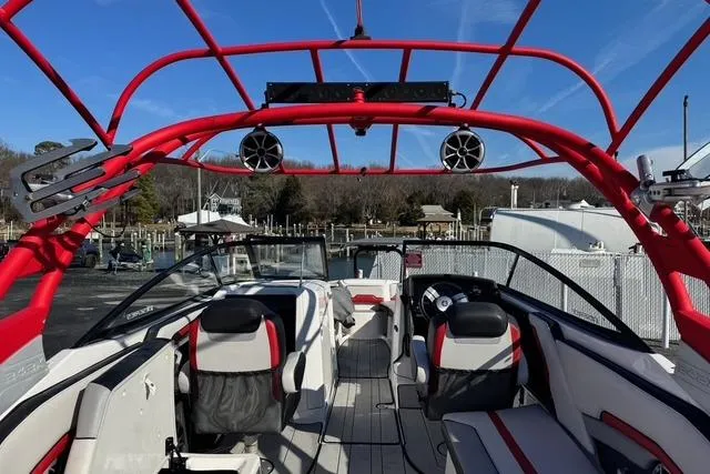 Slide: The Image of 2020 Yamaha Boats 242X E-Series interior with red accents and modern seating. - 18