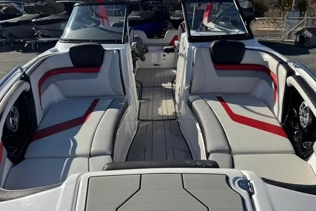 Slide: The Image of 2020 Yamaha Boats 242X E-Series interior with red accents and spacious seating. - 6