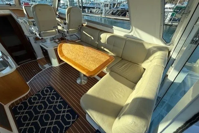 Slide: The Image of Interior of 2015 Back Cove 37 yacht with seating and table, docked at marina. - 12