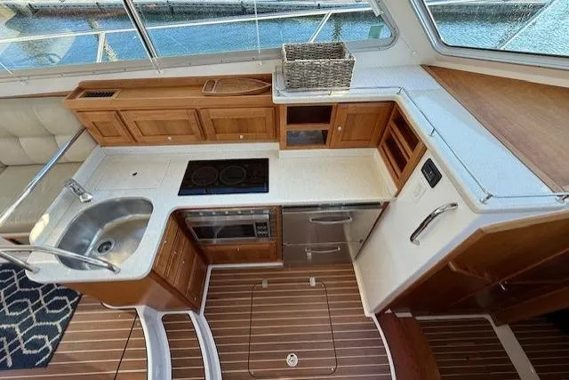 Slide: The Image of Luxurious 2015 Back Cove 37 yacht kitchen with wood cabinetry and modern appliances. - 13