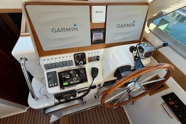 Slide: The Image of Helm of 2015 Back Cove 37 with Garmin navigation and wooden steering wheel. - 17