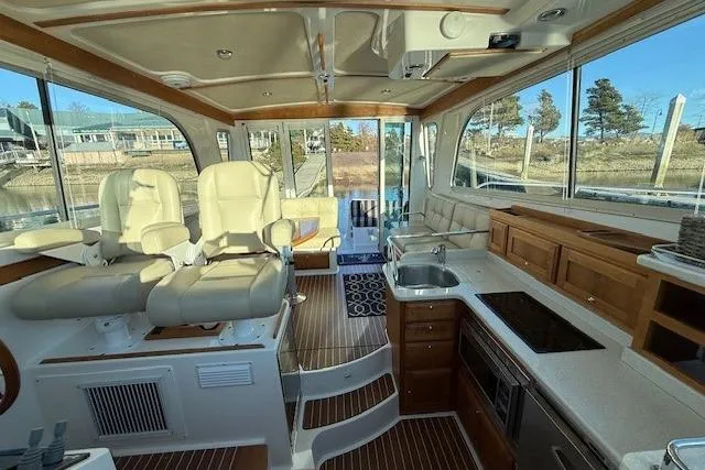 Slide: The Image of Interior of a 2015 Back Cove 37 yacht with modern seating and kitchen area. - 18