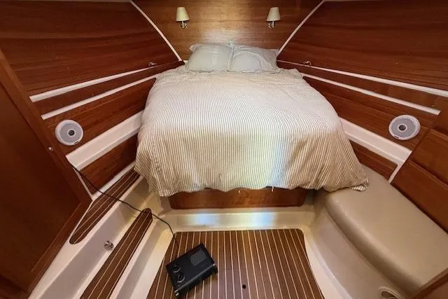 Slide: The Image of Cozy cabin interior of 2015 Back Cove 37 boat with wooden accents and bed. - 19