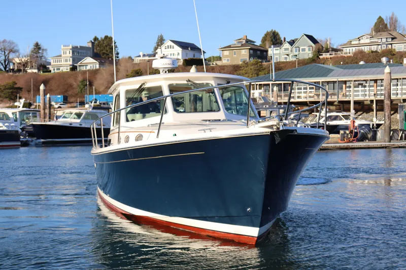 Slide: The Image of 2015 Back Cove 37 boat docked in a marina with waterfront homes. - 2