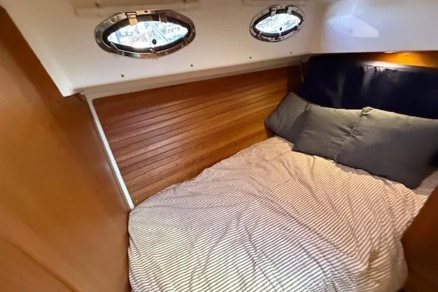Slide: The Image of Cozy cabin interior of 2015 Back Cove 37 yacht with wood paneling and portholes. - 23