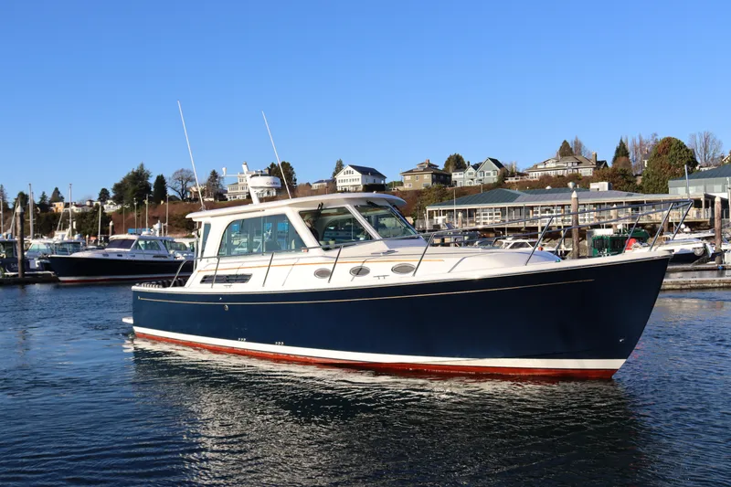 Slide: The Image of 2015 Back Cove 37 boat docked in a marina under clear blue skies. - 3