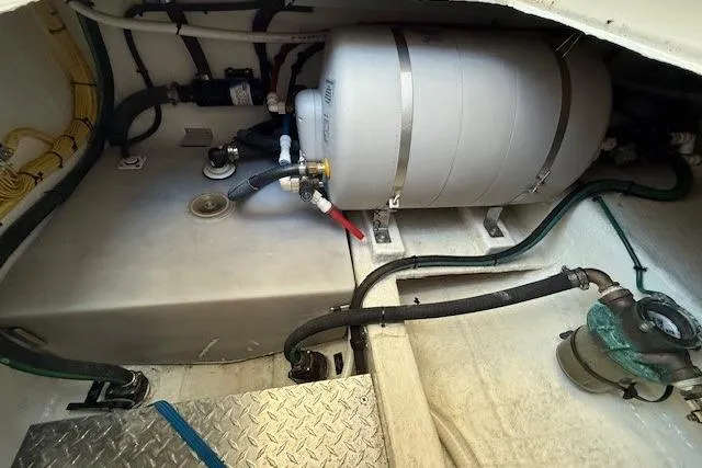 Slide: The Image of Engine room of 2015 Back Cove 37 boat with water tank and hoses. - 31