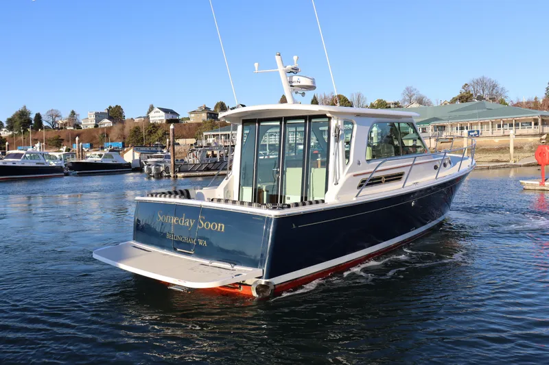 Slide: The Image of 2015 Back Cove 37 boat on water, sunny day, marina background. - 5